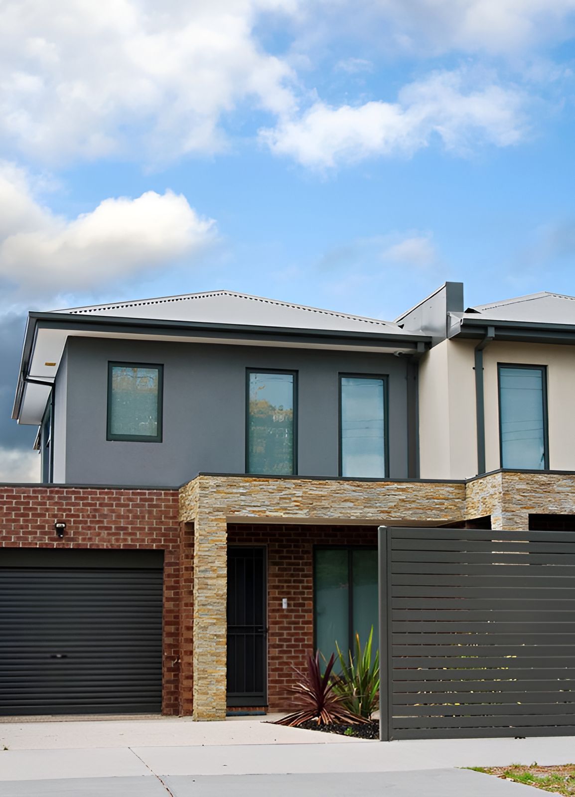A House With A Garage And A Fence In Front Of It — Anytime Conveyancing In Hallidays Point, NSW