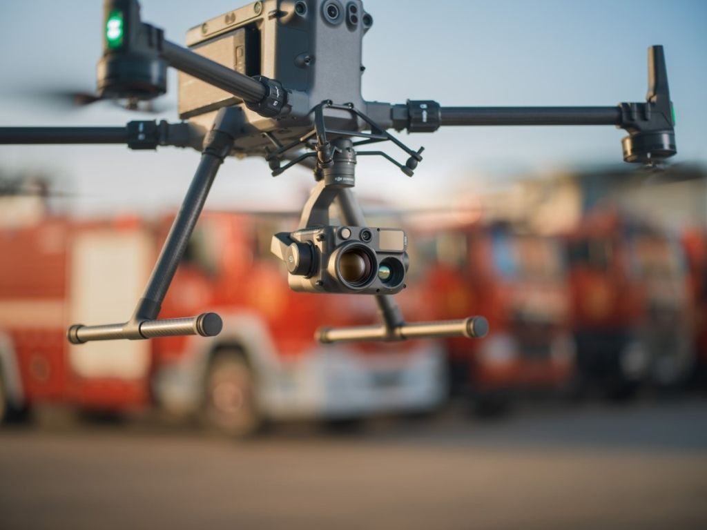 A drone with a camera on it is flying in the sky.