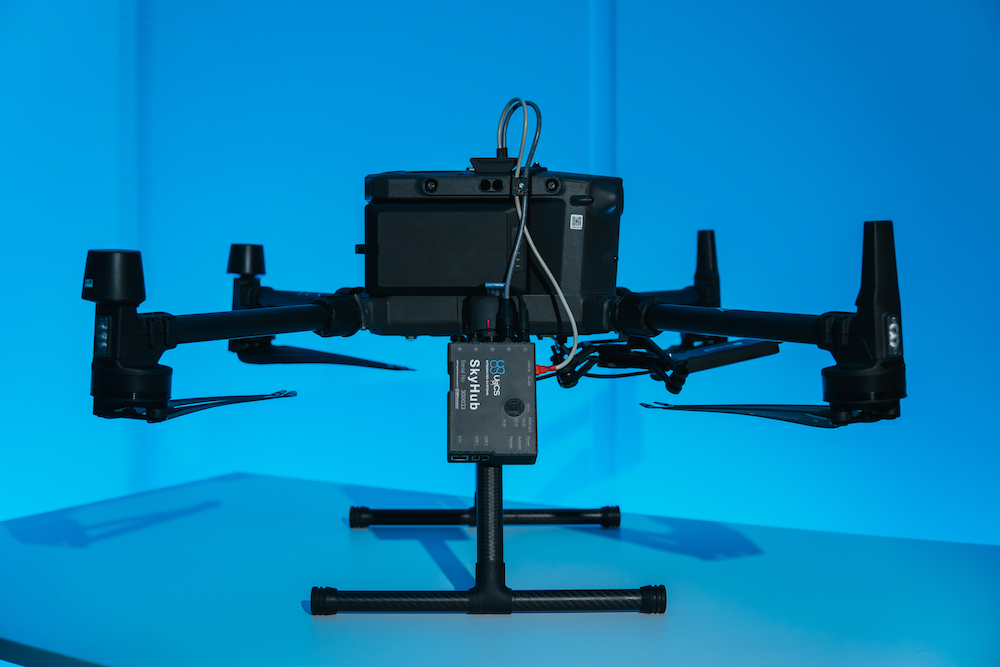 A drone is sitting on top of a blue table.