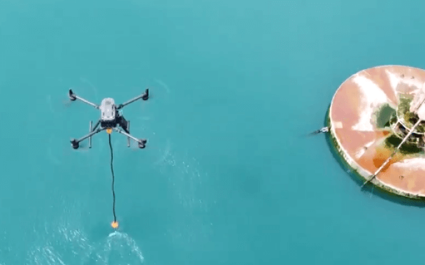 An aerial view of a drone flying over a pizza in the water.