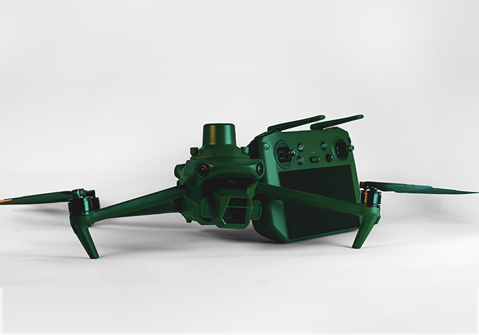 A green drone with a remote control attached to it