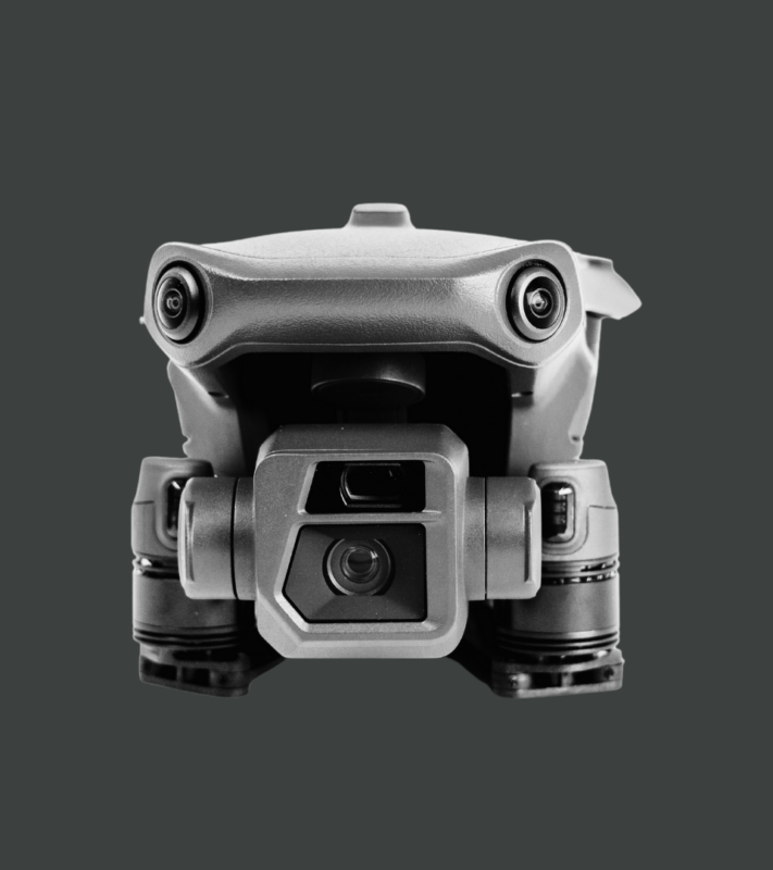 A drone with a camera attached to it is sitting on a tripod.