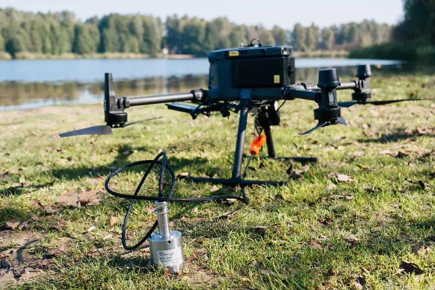 A drone with a camera attached to it is sitting on a tripod.