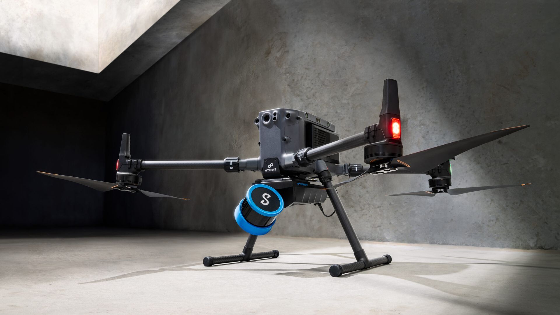A drone is sitting on the ground in a concrete room.