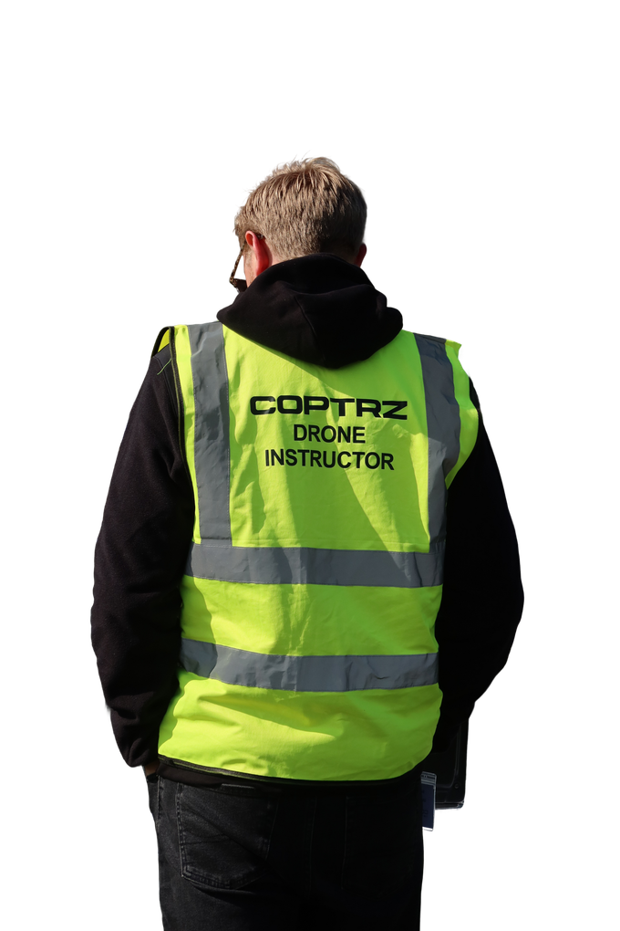 A man wearing a yellow vest that says cortaz drone instructor
