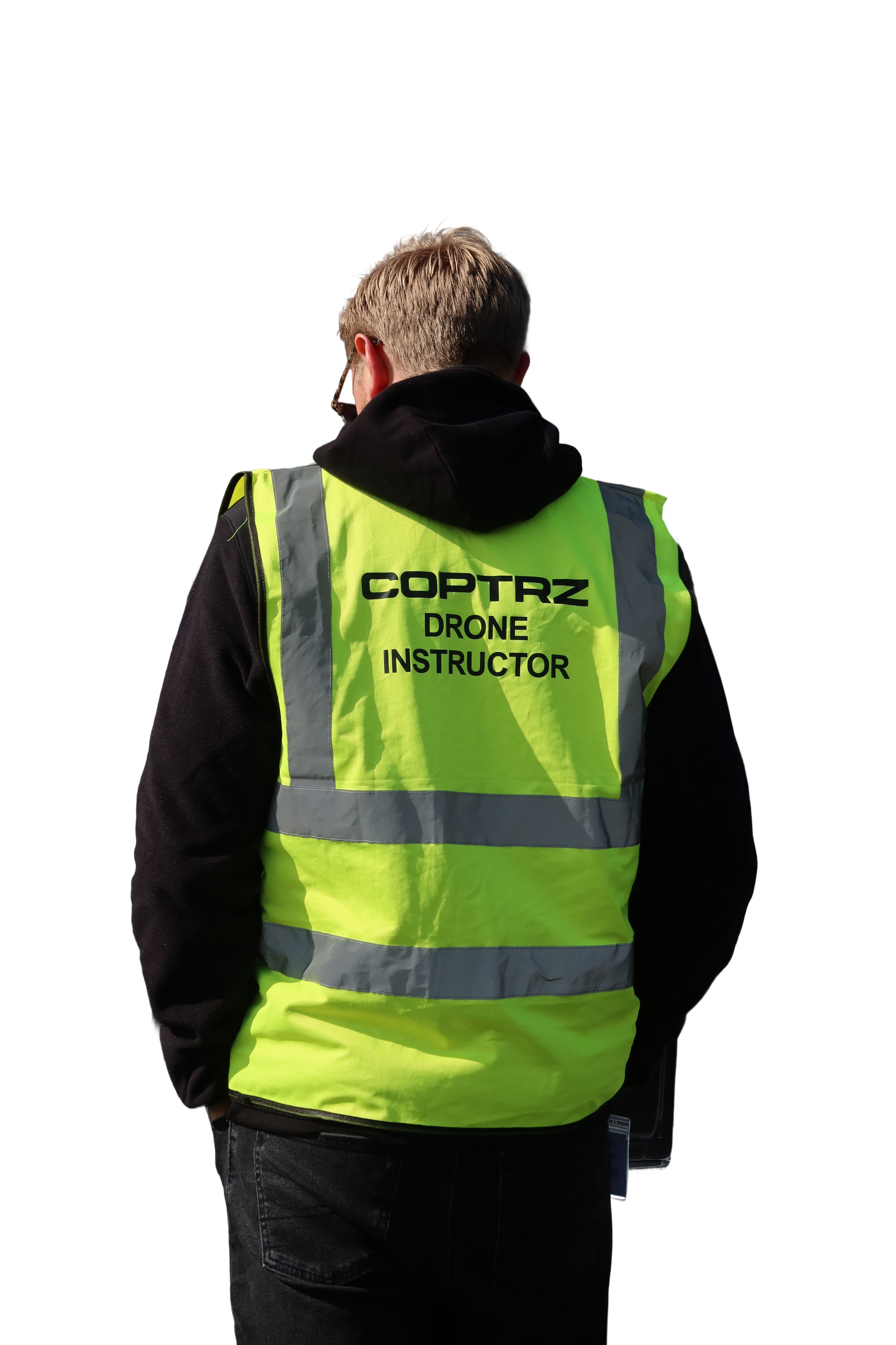 A man wearing a yellow vest that says cortaz drone instructor