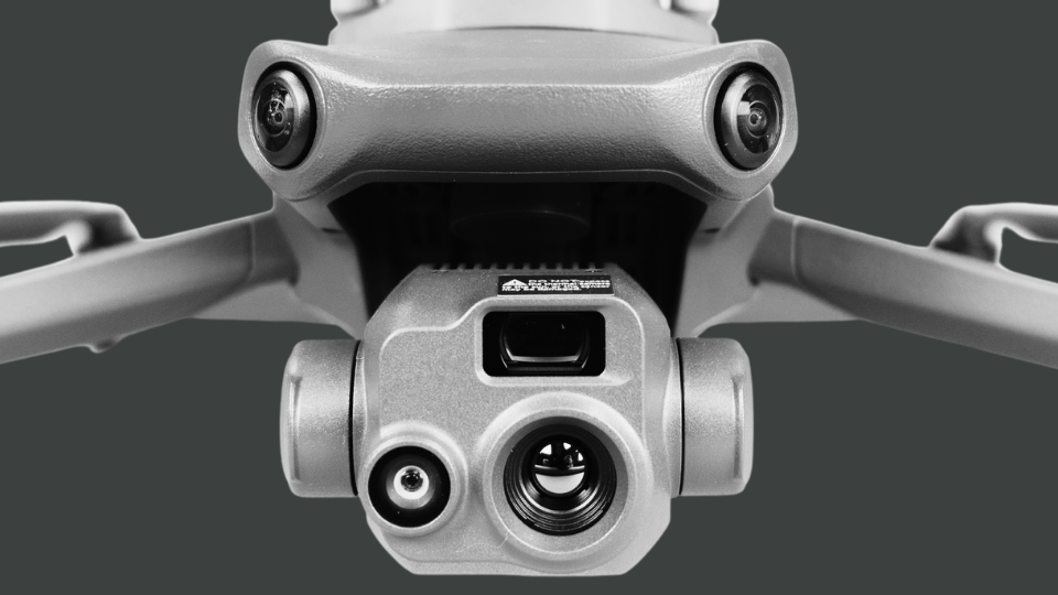 A camera is sitting on top of a gimbal in the rain.