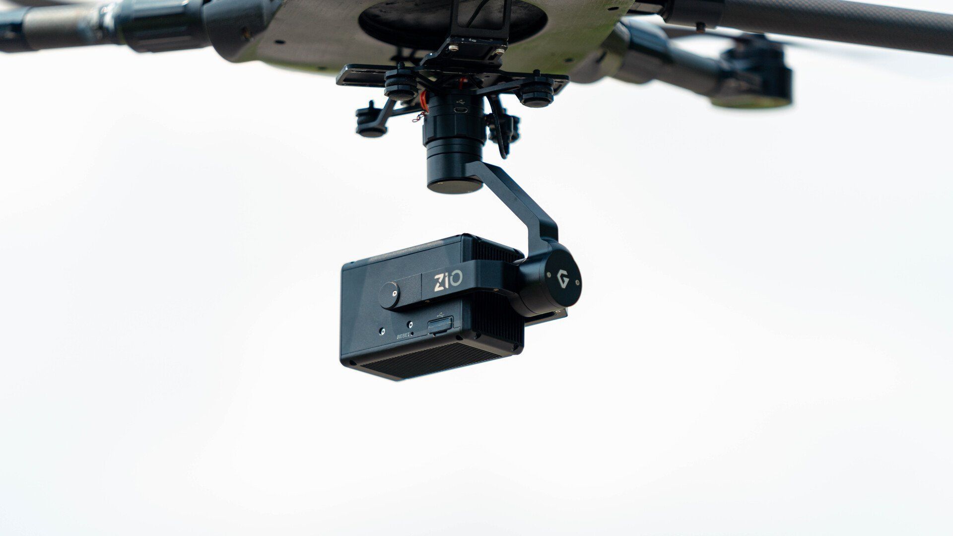A drone with a camera attached to it is sitting on a tripod.