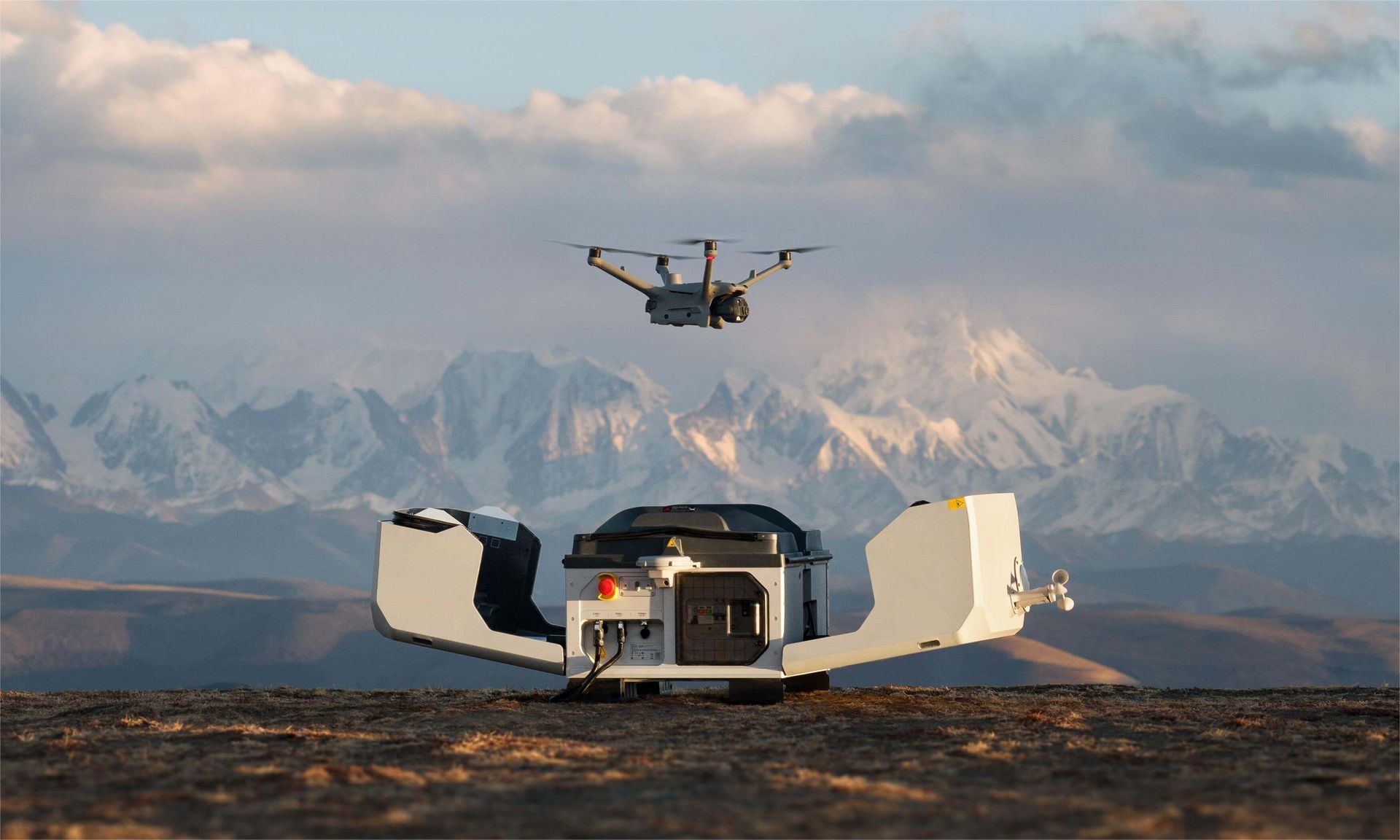 A drone with a camera attached to it is sitting on a tripod.