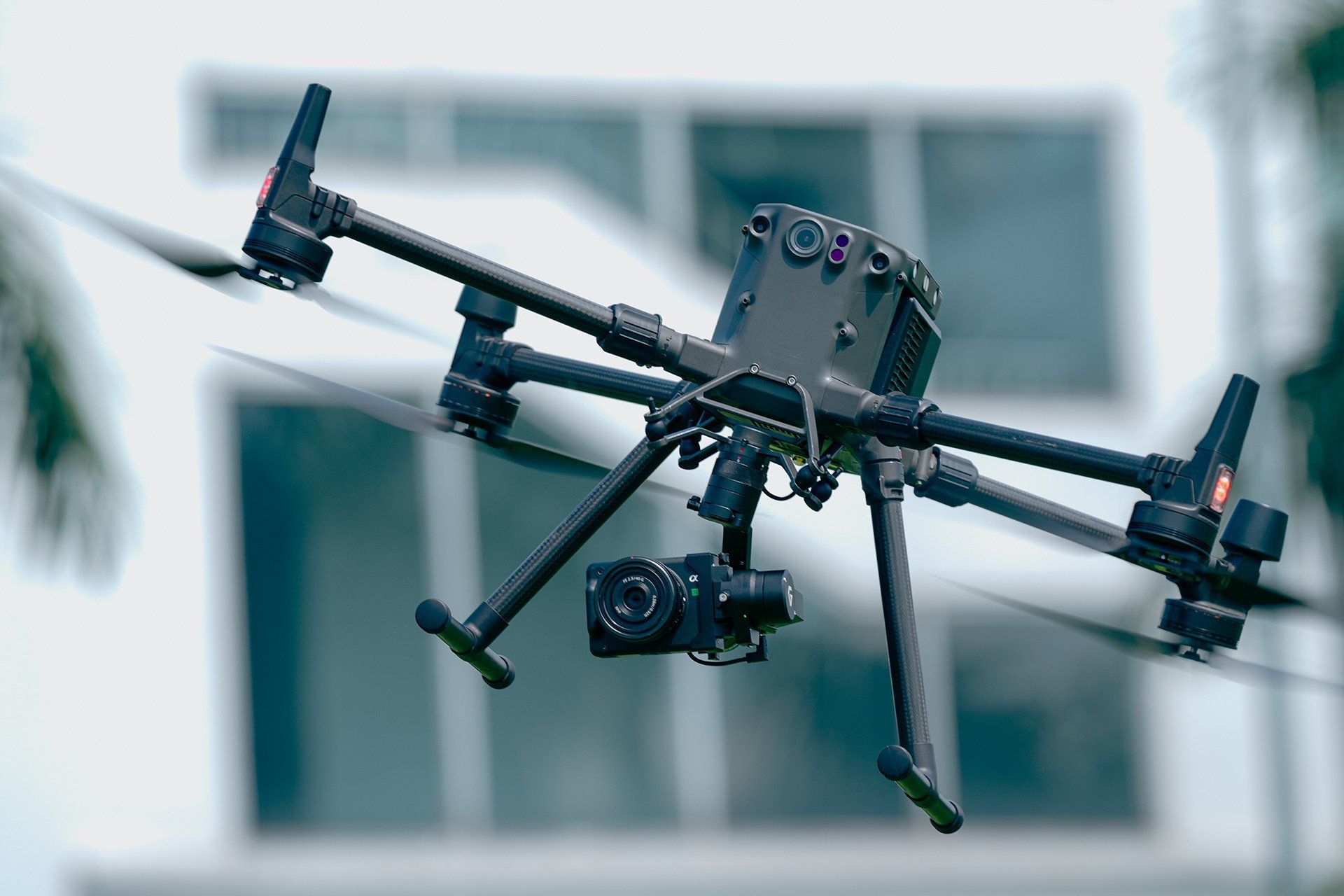 A drone with a camera attached to it is sitting on the ground.
