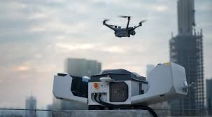 A drone is flying over a building in a city.