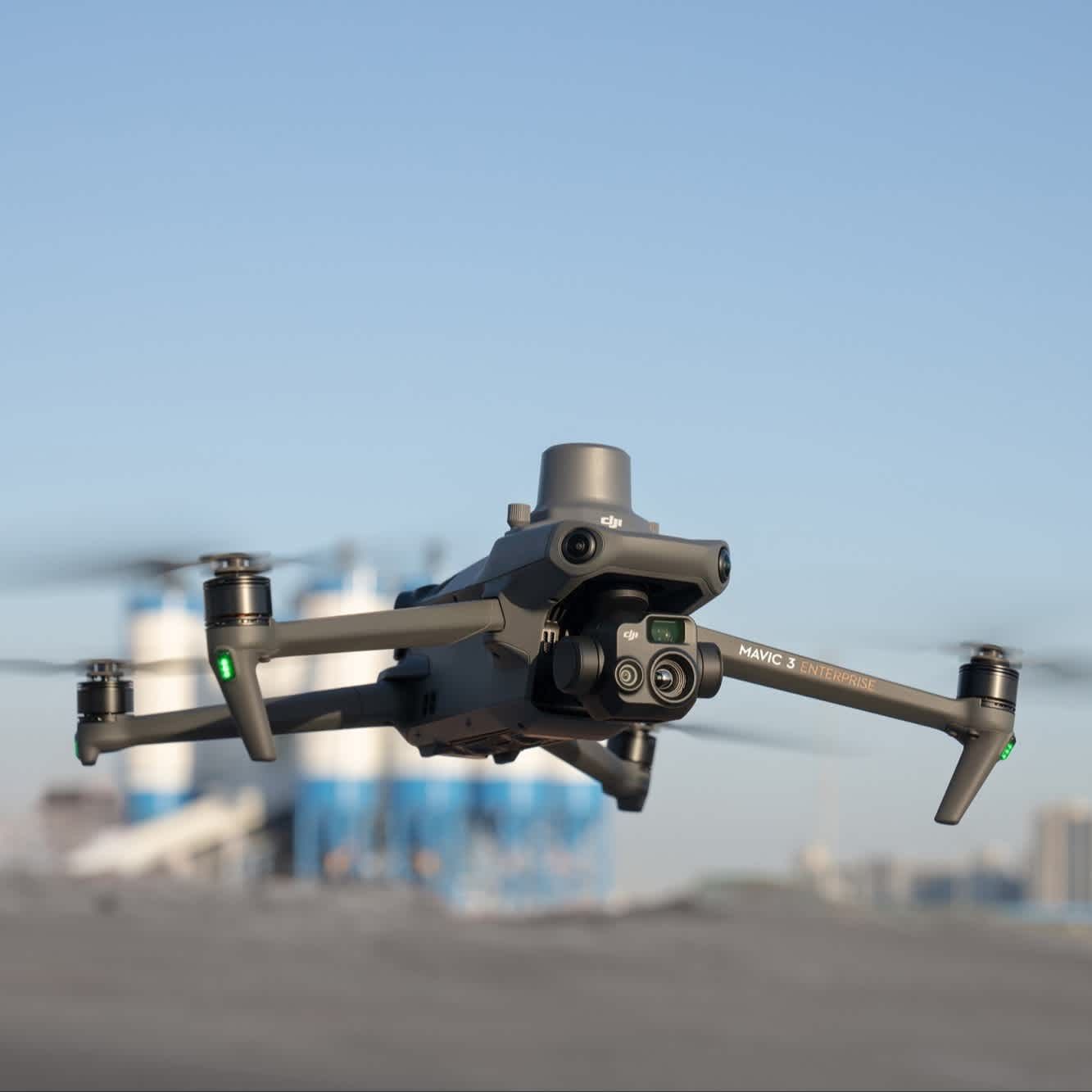 A drone with a camera on it is flying in the sky.