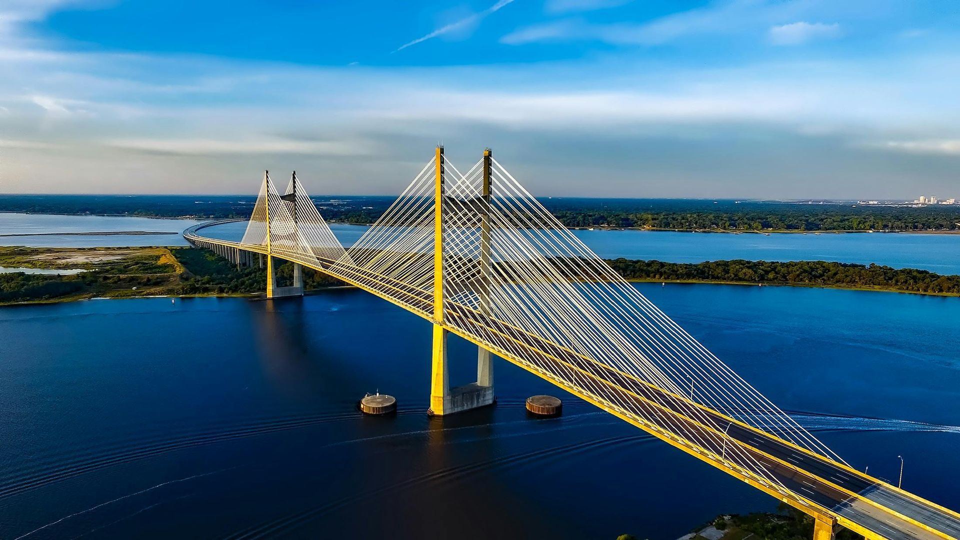 An aerial view of a bridge over a body of water.