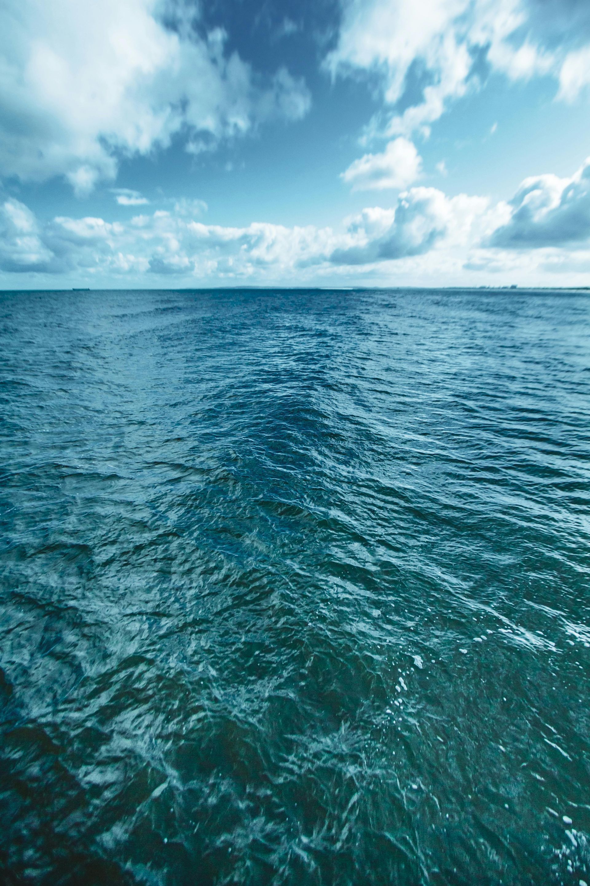 A large body of water with a blue sky in the background.