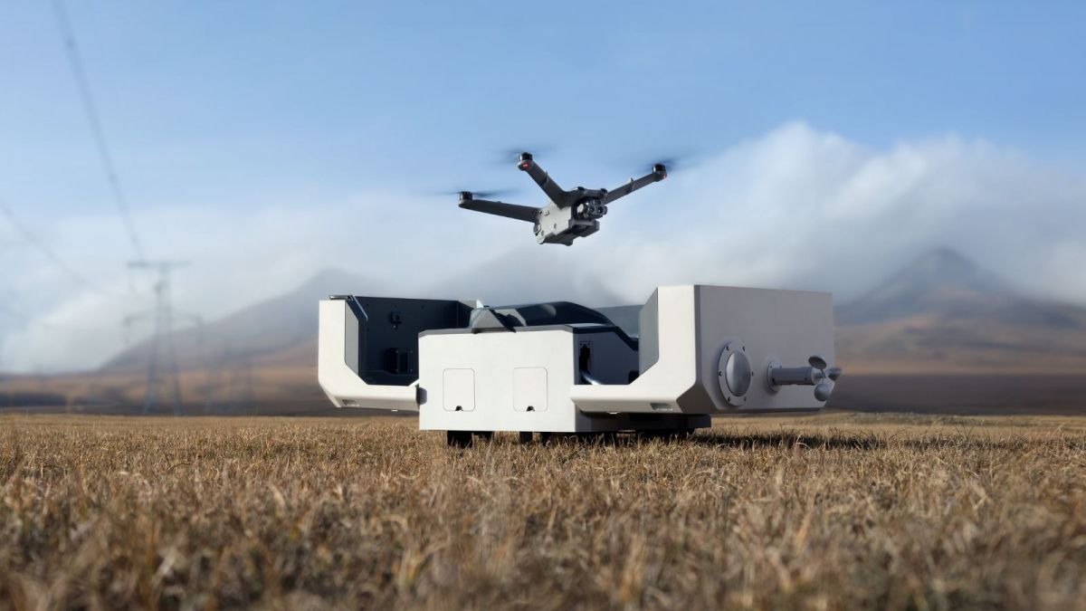 A drone with a camera attached to it is sitting on the ground.