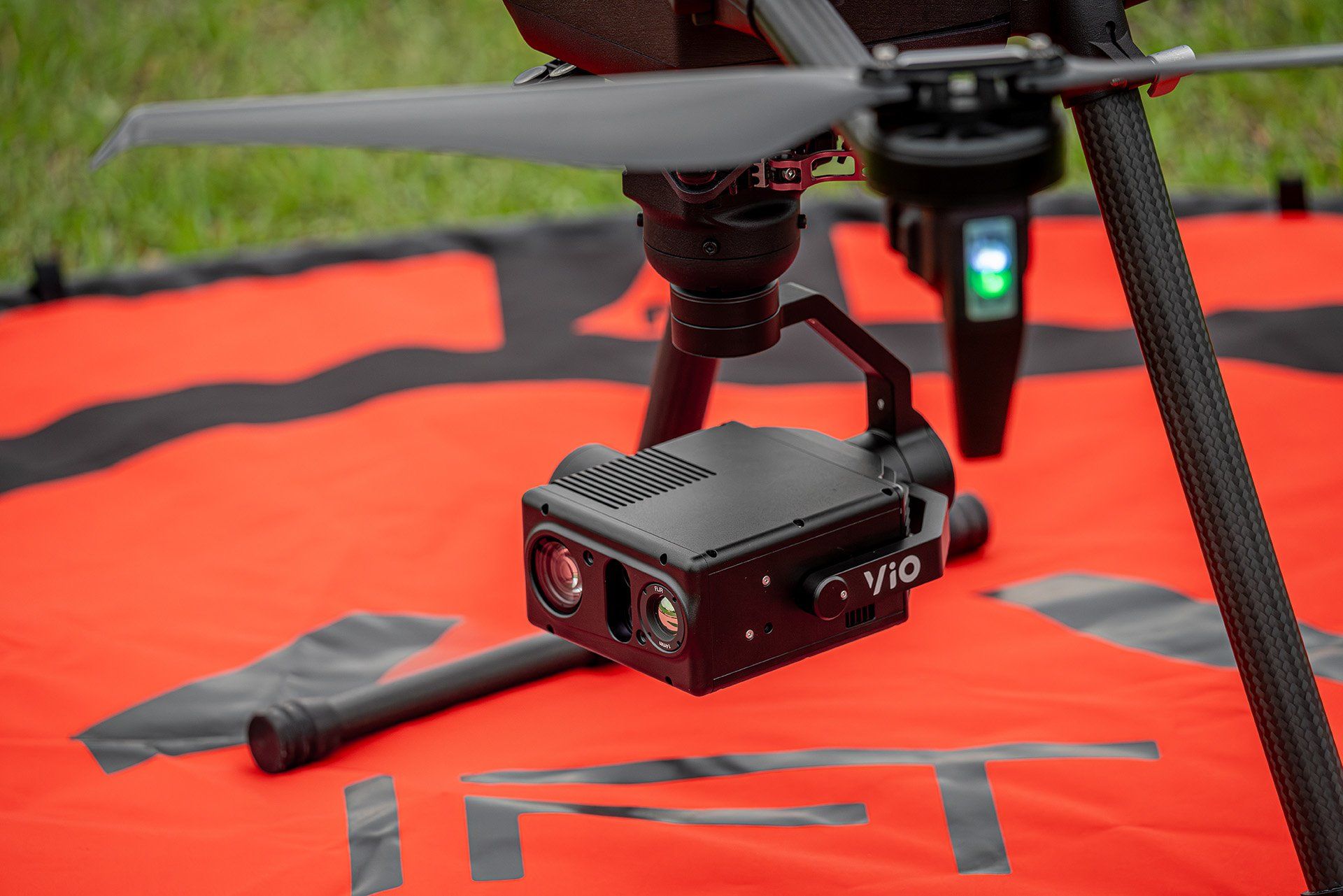 A camera is sitting on top of a gimbal in the rain.