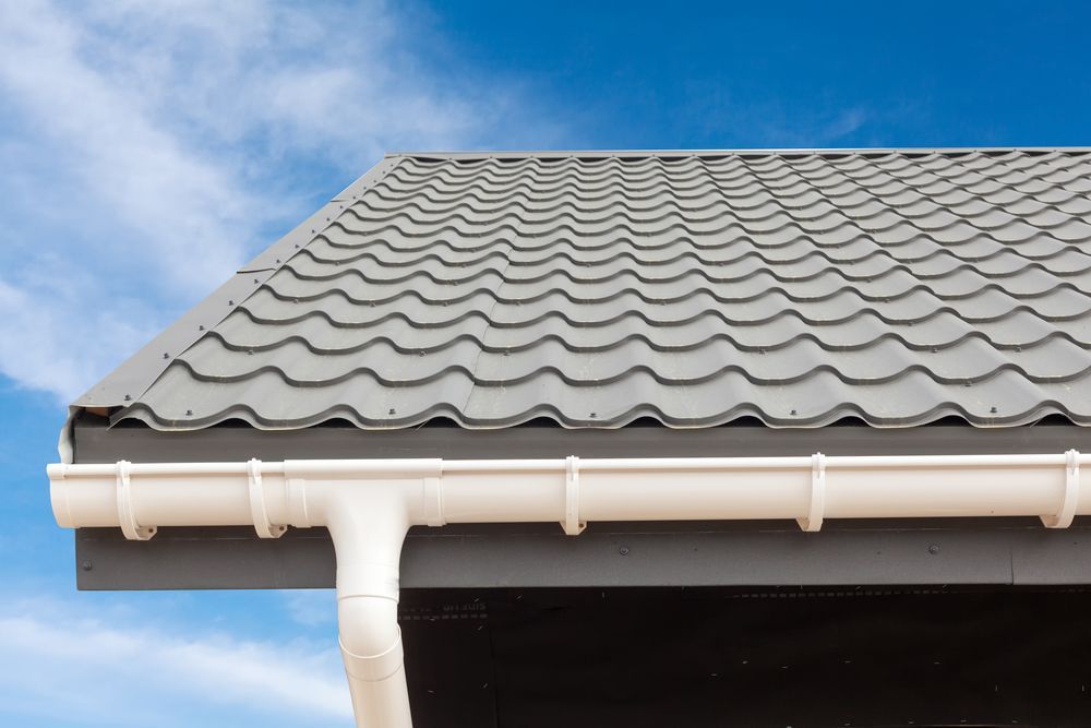 A Close Up of a Roof With a White Gutter and a Blue Sky in the Background — HTH Sheetmetal Mackay in Mackay, QLD