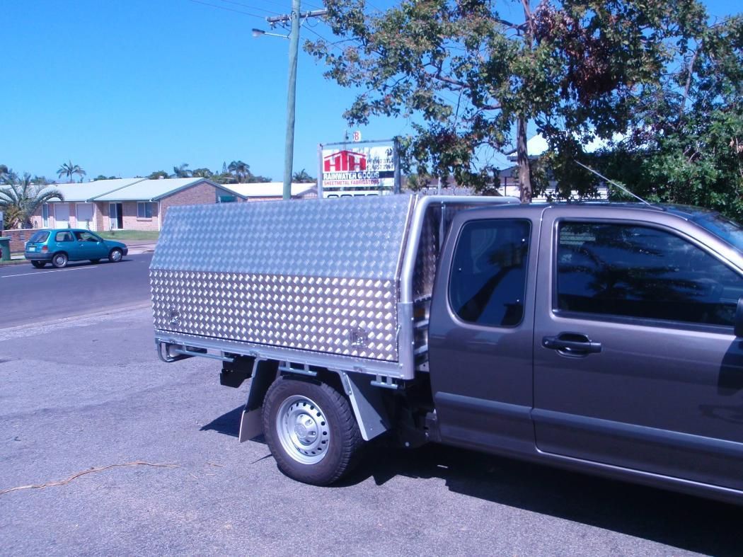 A Silver Truck With a Canopy is Parked on the Side of the Road — HTH Sheetmetal Mackay in Mackay, QLD