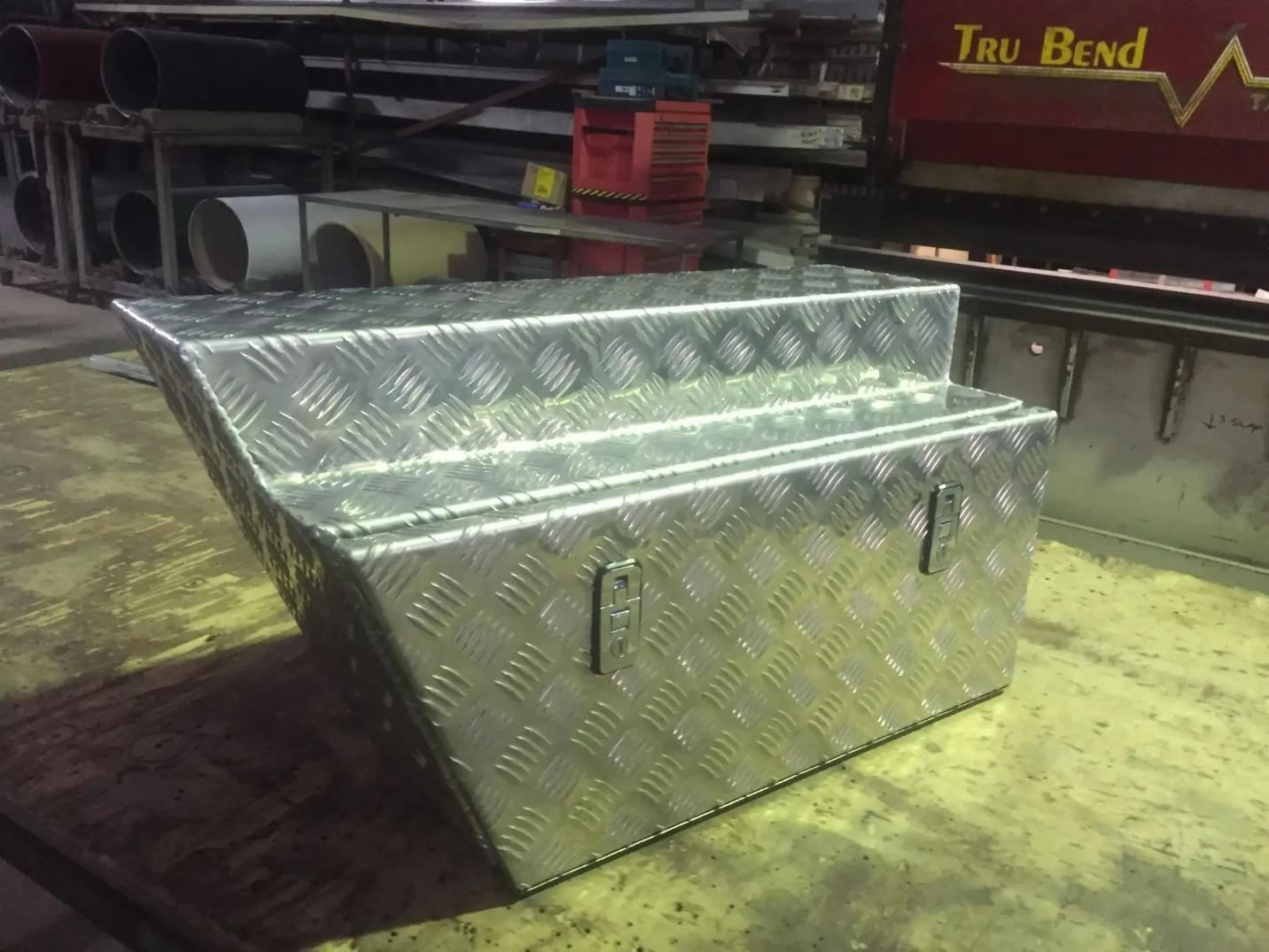A Metal Box is Sitting on a Table in Front of a Machine That Says Try Bend — HTH Sheetmetal Mackay in Mackay, QLD