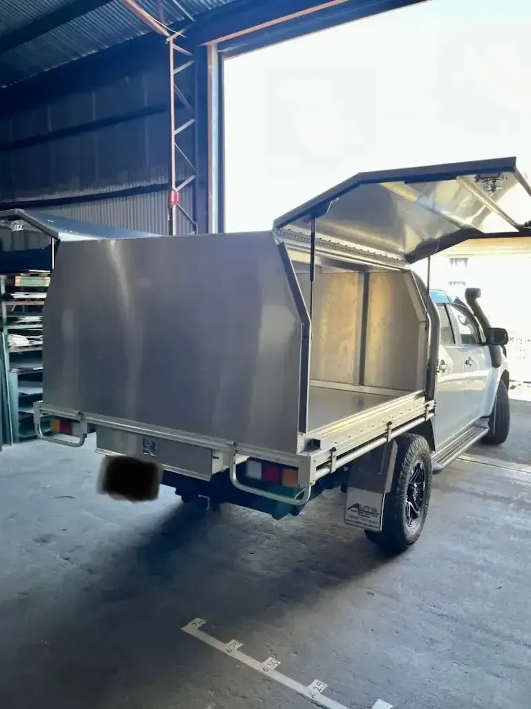 A Truck With a Canopy on Top of It is Parked in a Garage — HTH Sheetmetal Mackay in Mackay, QLD