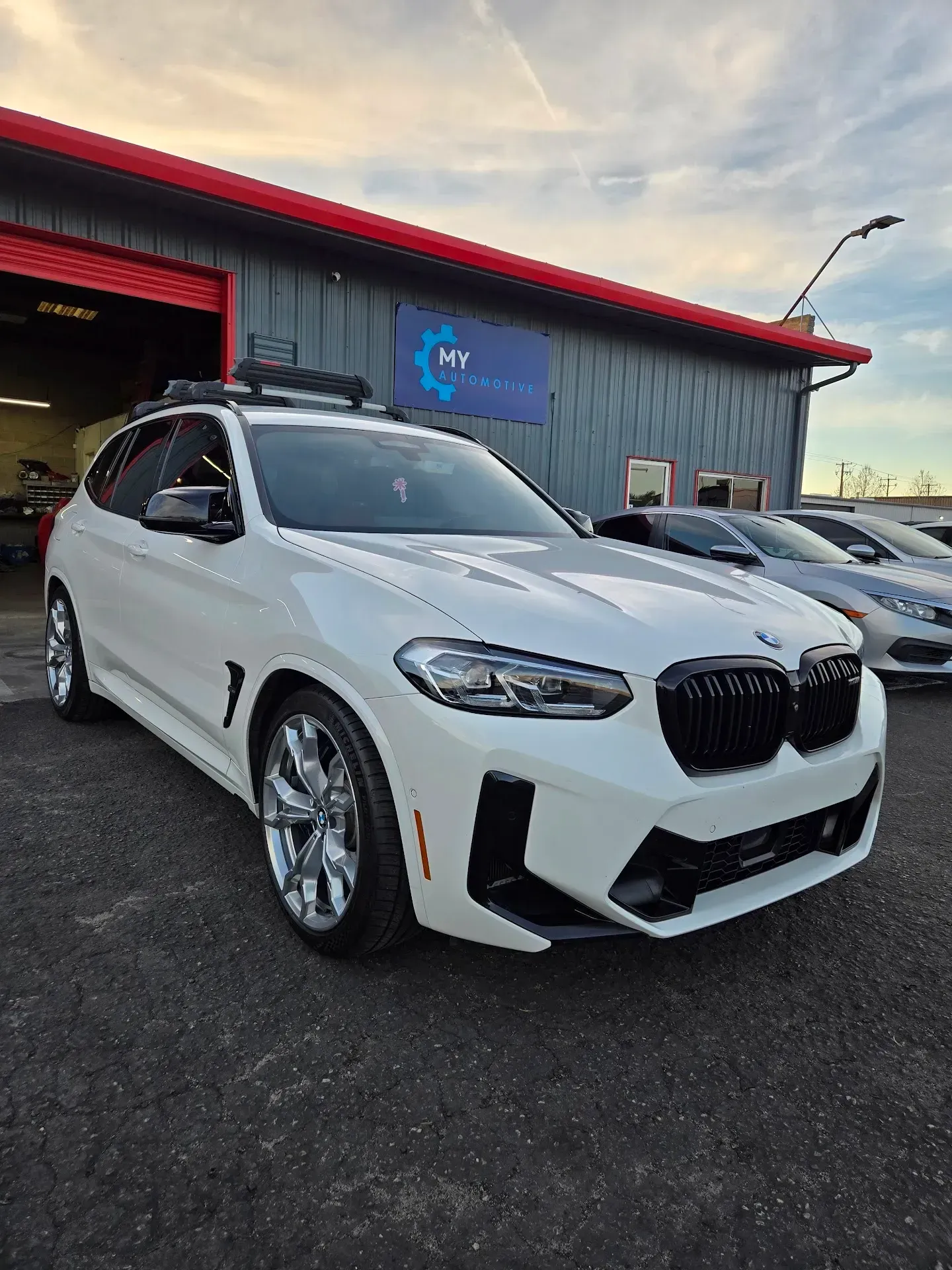 White BMW Parked in Front of The Shop | My Automotive