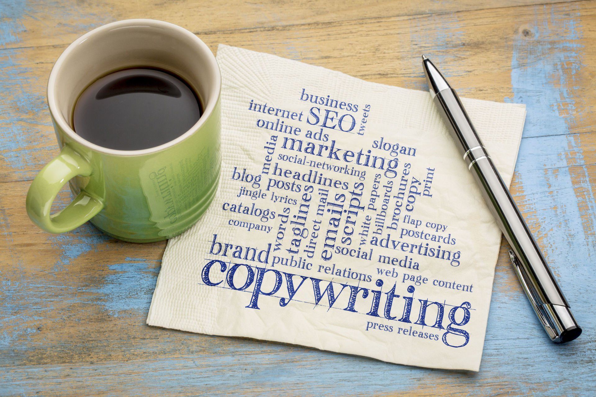 A cup of coffee is sitting on a napkin with the word copywriting written on it.