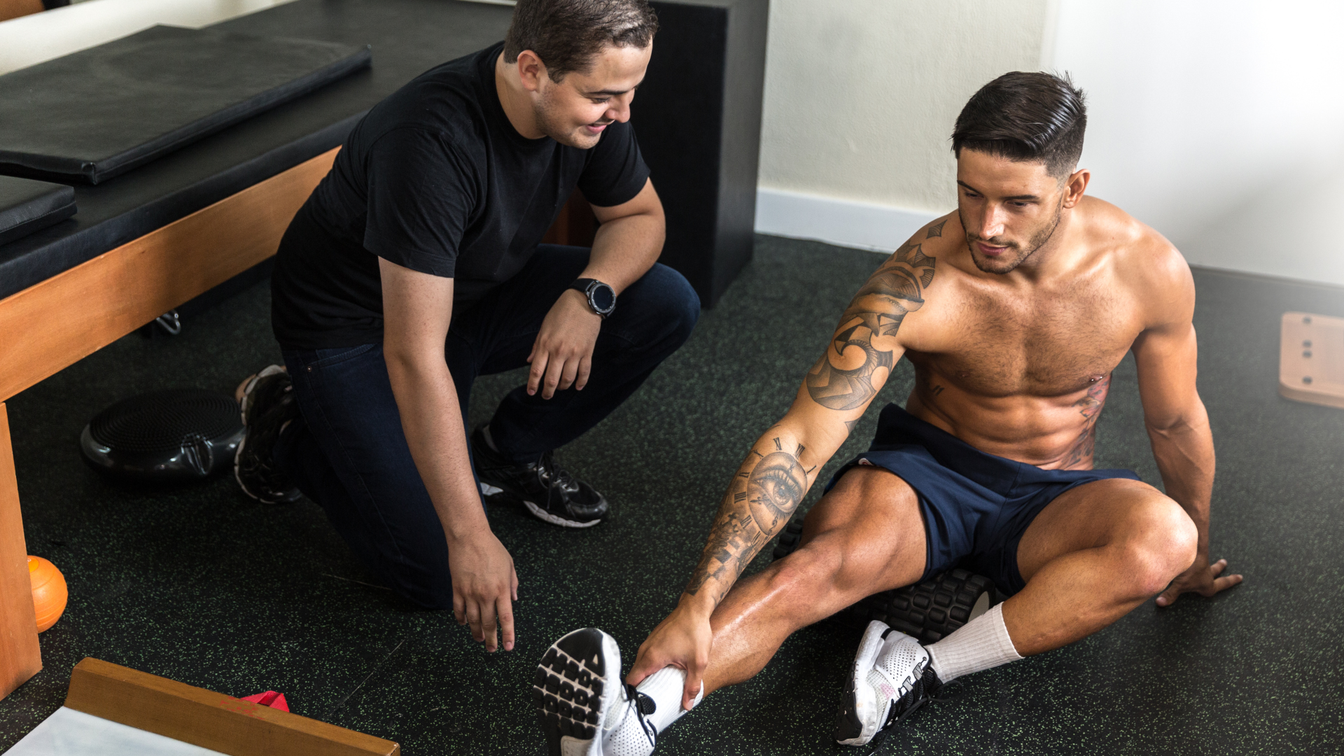 A woman is laying on a table with her hands in the air.