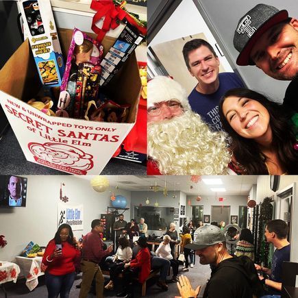 A group of people are gathered around a box that says secret santas