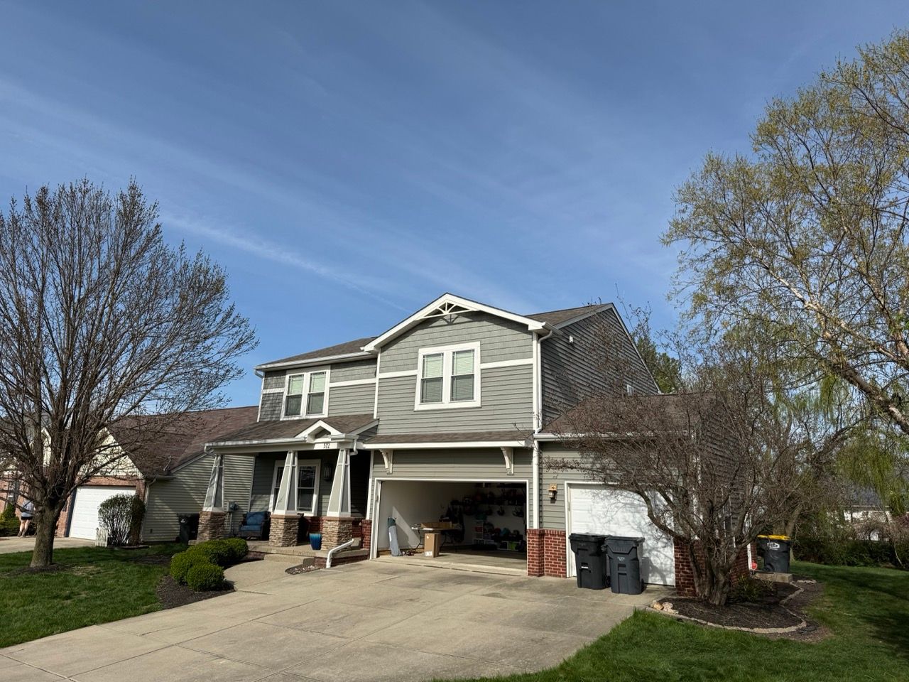 A large house with a garage and a driveway in a residential area.