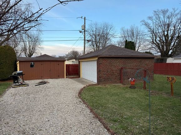There is a garage and a shed in the backyard.