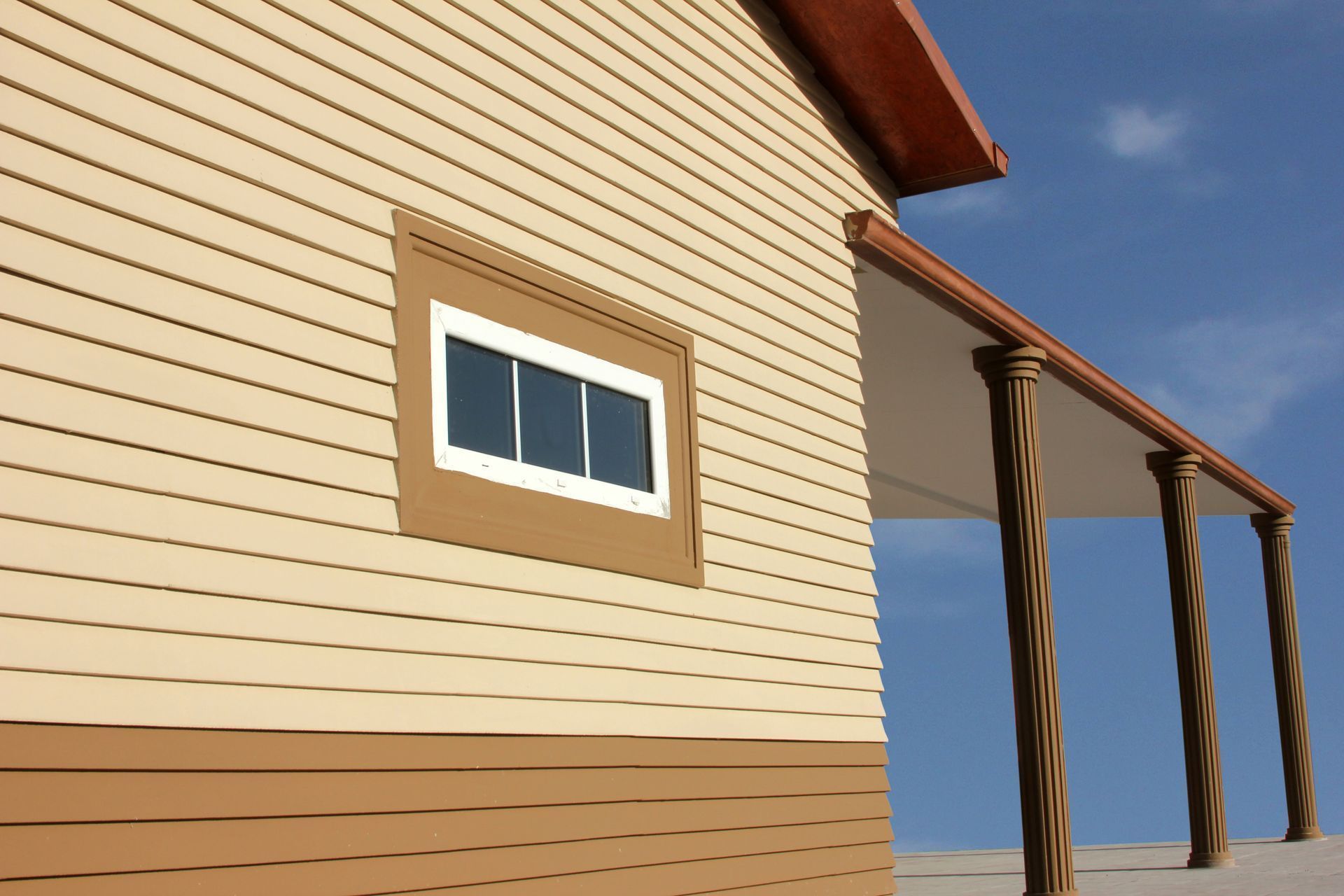 A house with a porch and a window on the side