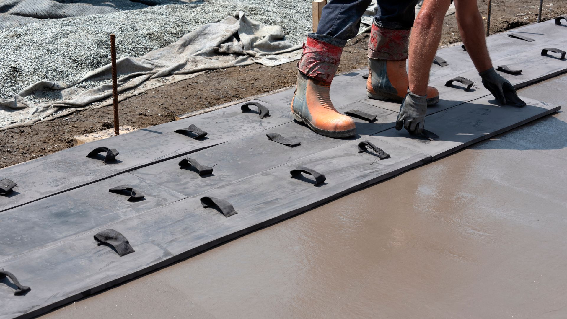 A couple of people are standing on a concrete surface.