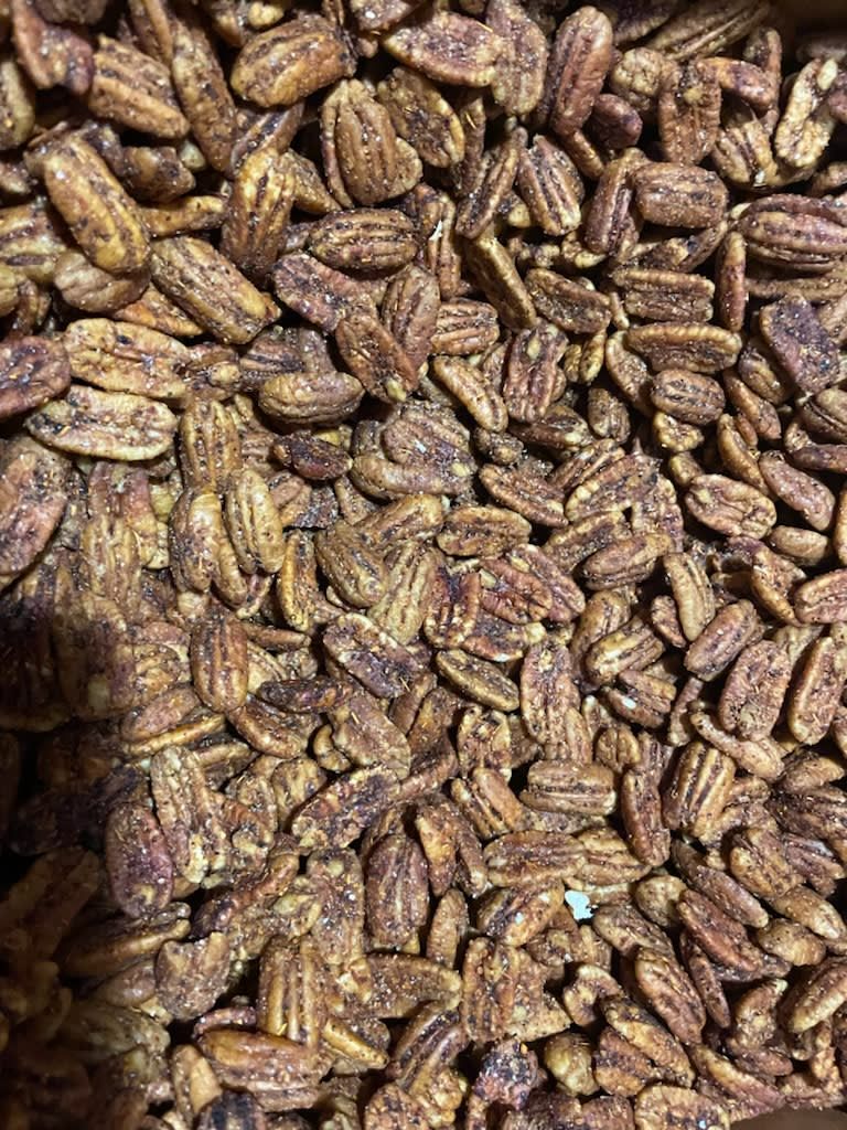 A pile of pecans sitting on top of each other on a table.