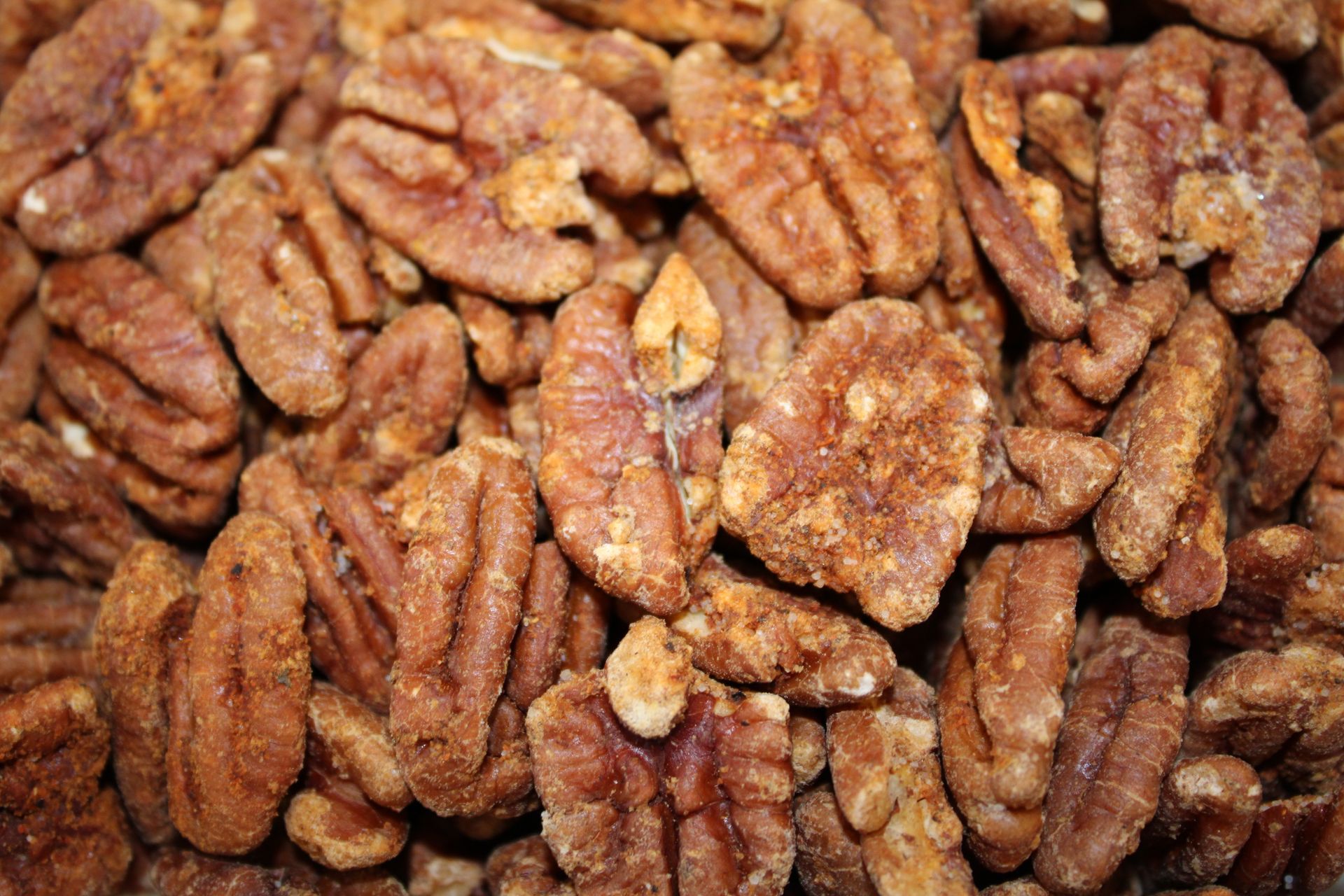 A close up of a pile of pecans on a table.