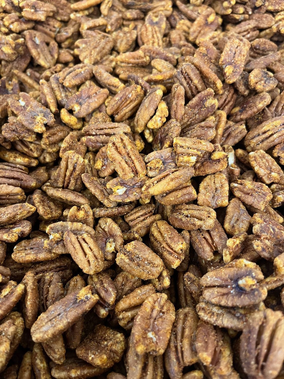 A pile of pecans sitting on top of each other on a table.