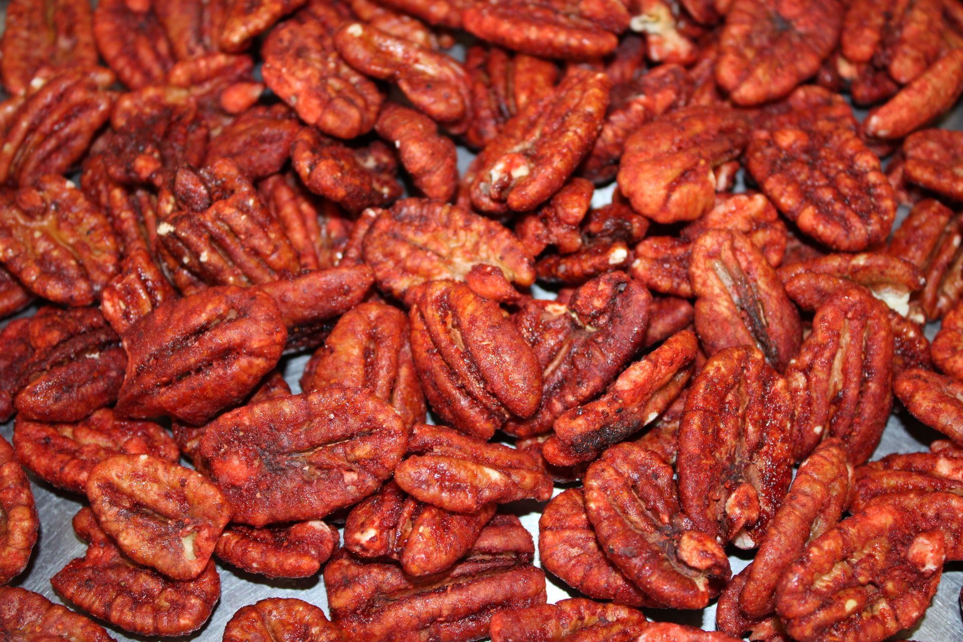 A pile of pecans are sitting on a table.