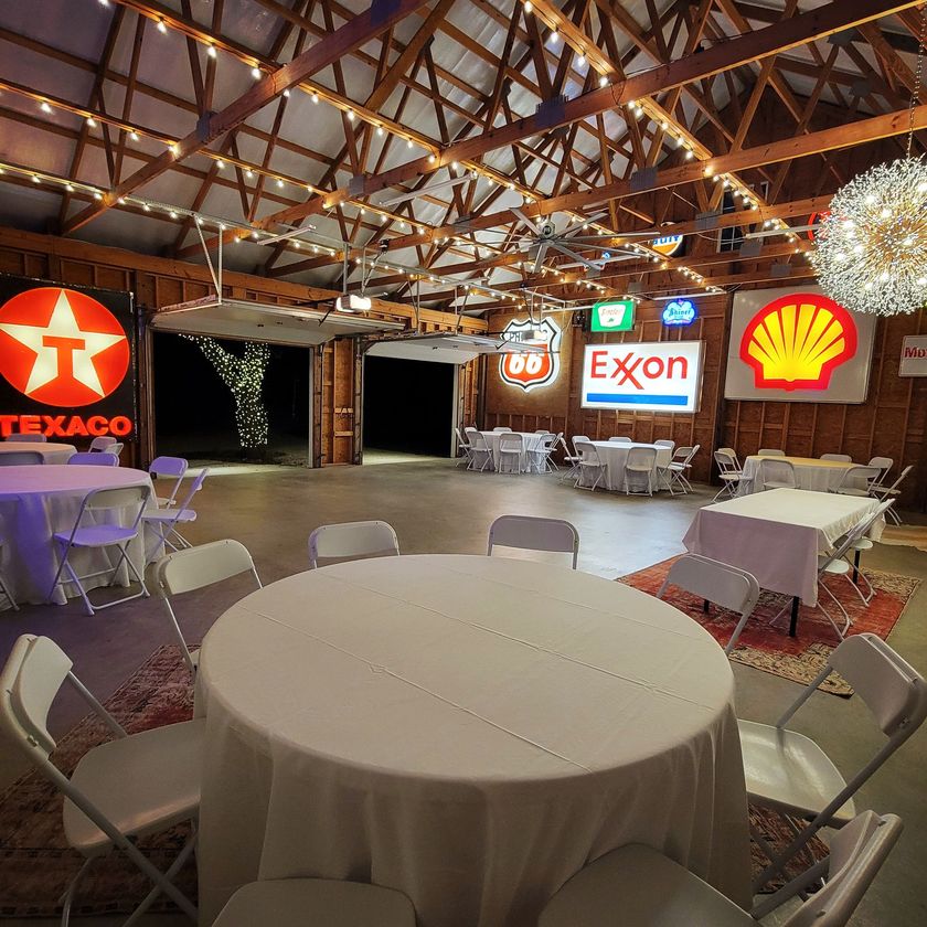 A large room with tables and chairs and signs for texaco and exxon