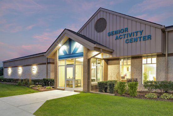 Senior Activity Center building with a welcoming entrance, lit at dusk.