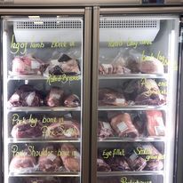 A refrigerator filled with lots of meat in a butcher shop-Butcher in Darwin