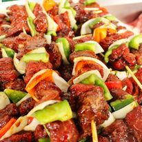 A close up of a plate of food with meat and vegetables on skewers-Butcher in Darwin