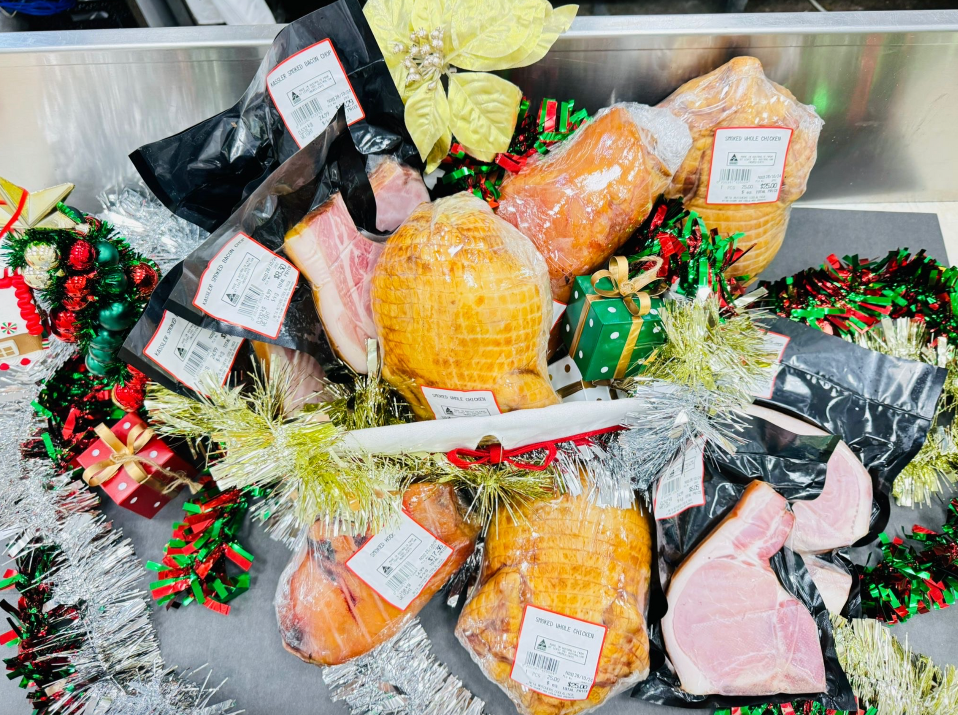 A variety of meats are sitting on a table with christmas decorations-Butcher in Darwin