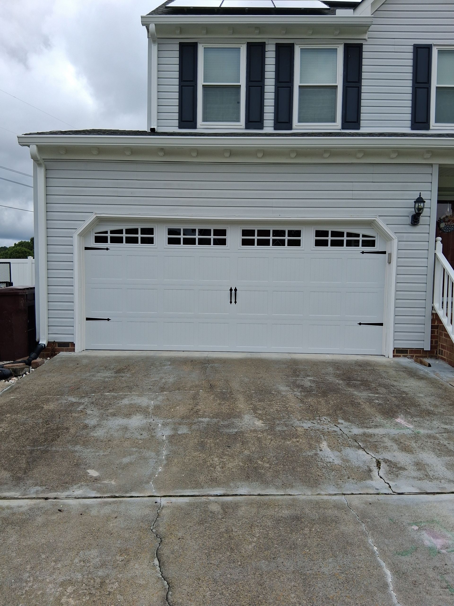 A woman in a green shirt is laughing with her mouth open