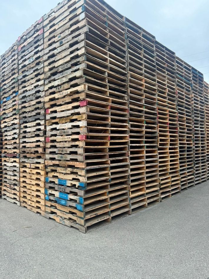 A pile of wooden pallets stacked on top of each other