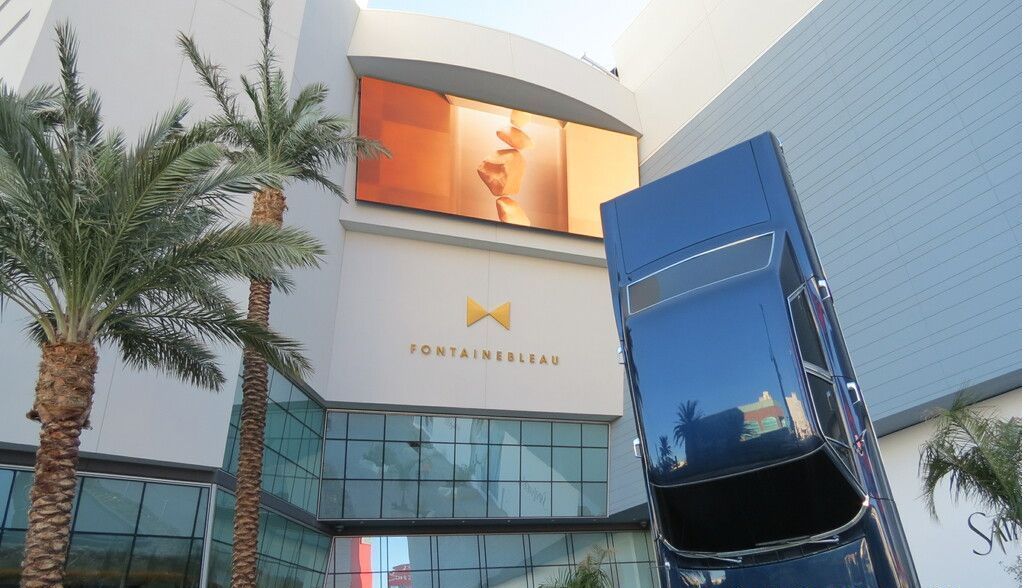 A man is painting a concrete surface with a brush.