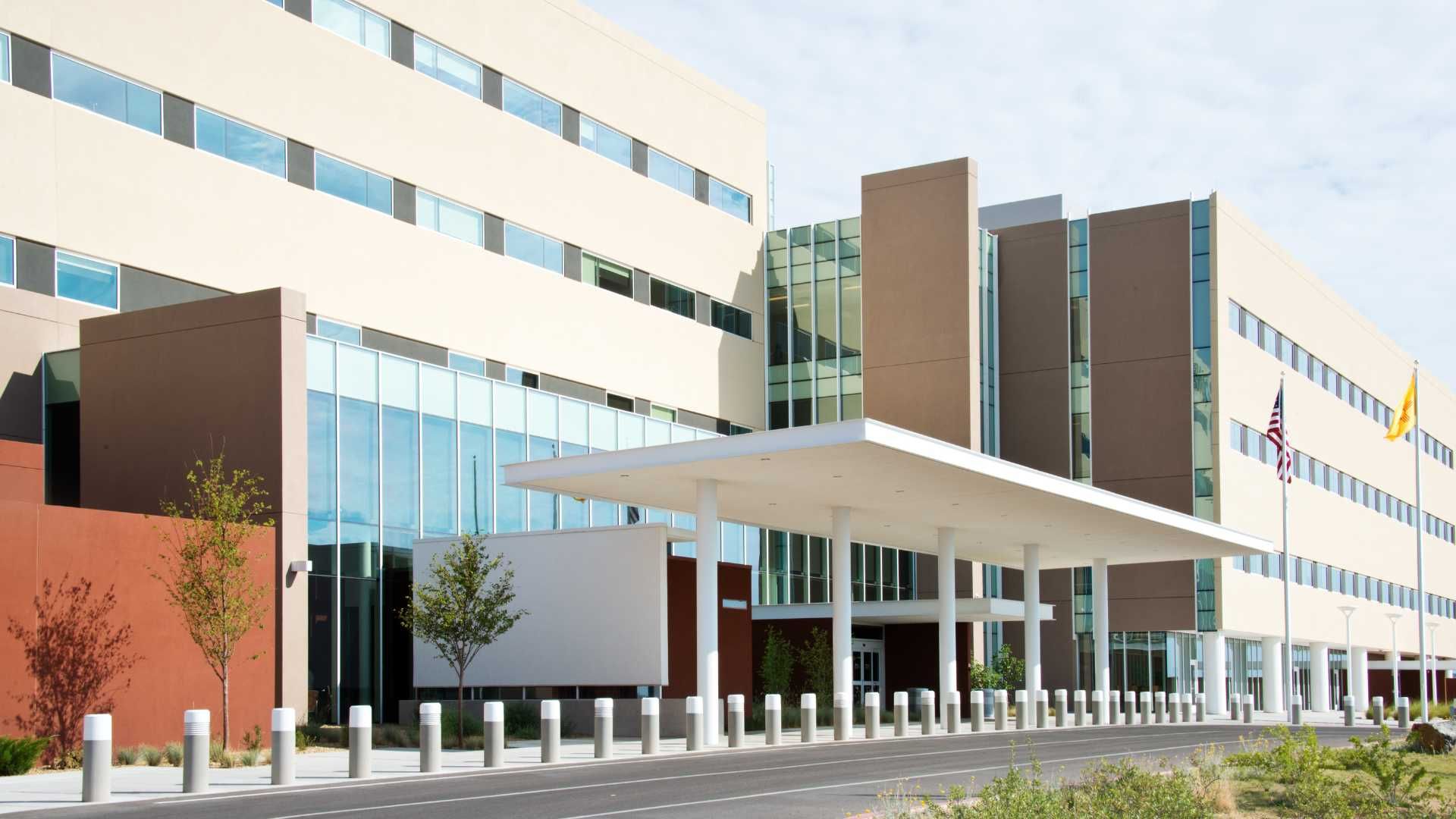 A large building with a lot of windows and a canopy over the entrance.