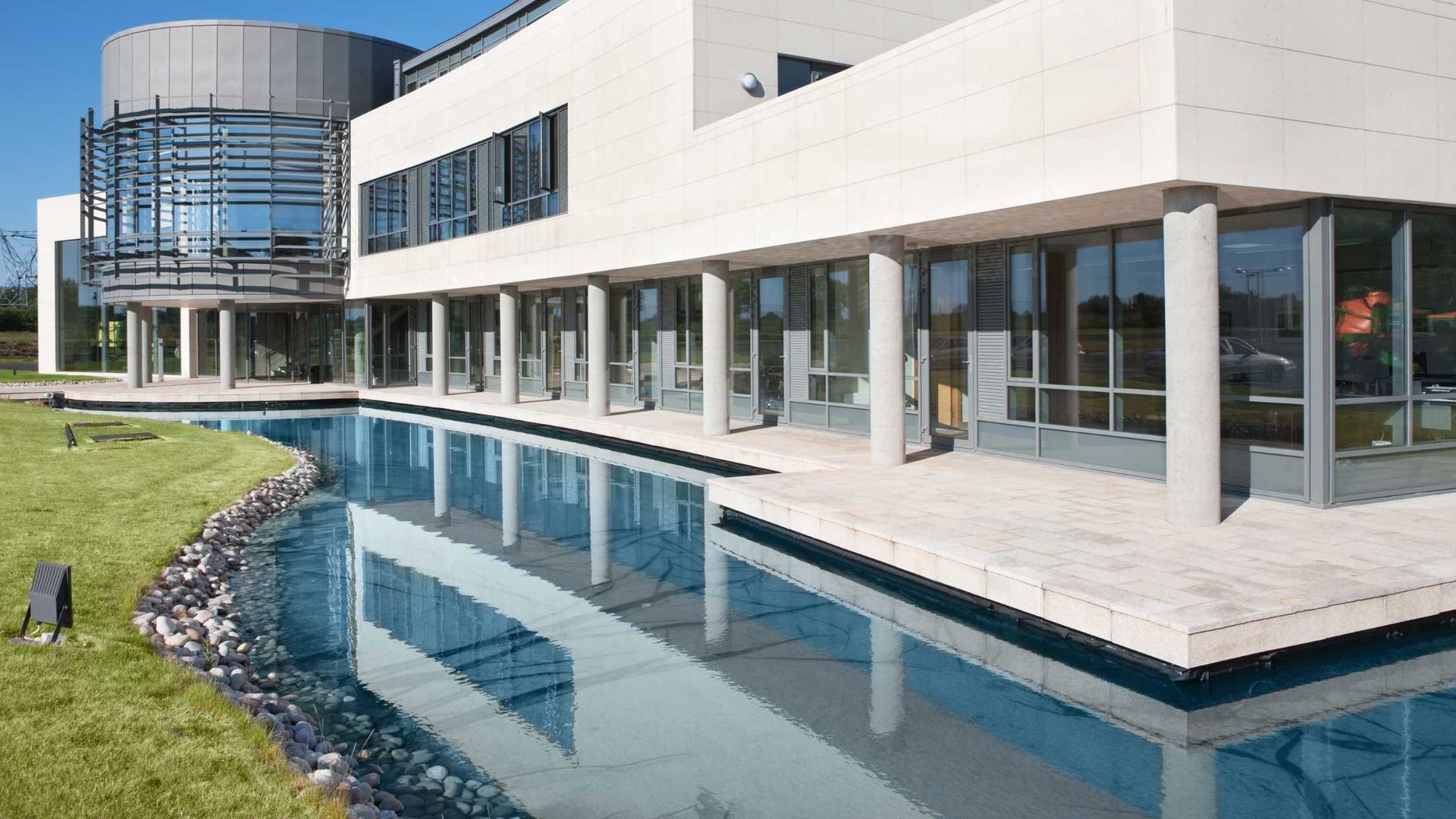 A large building with a swimming pool in front of it