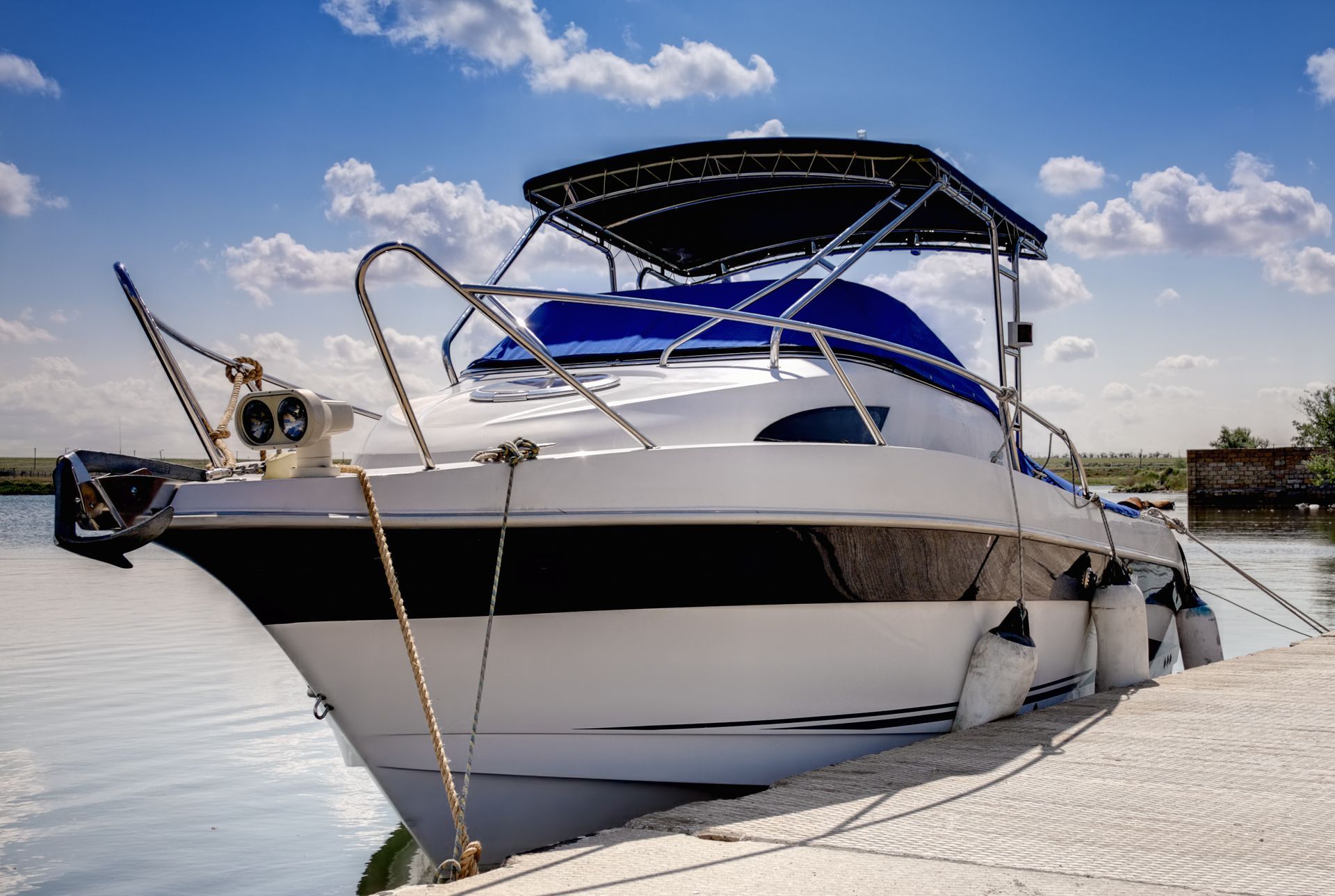 A white and black motorboat is docked
