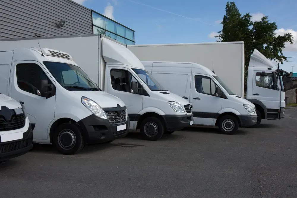 A Person Wearing White Gloves Handling Car Tires On A Shelf In A Store — THG Tires in Gladstone Central, QLD