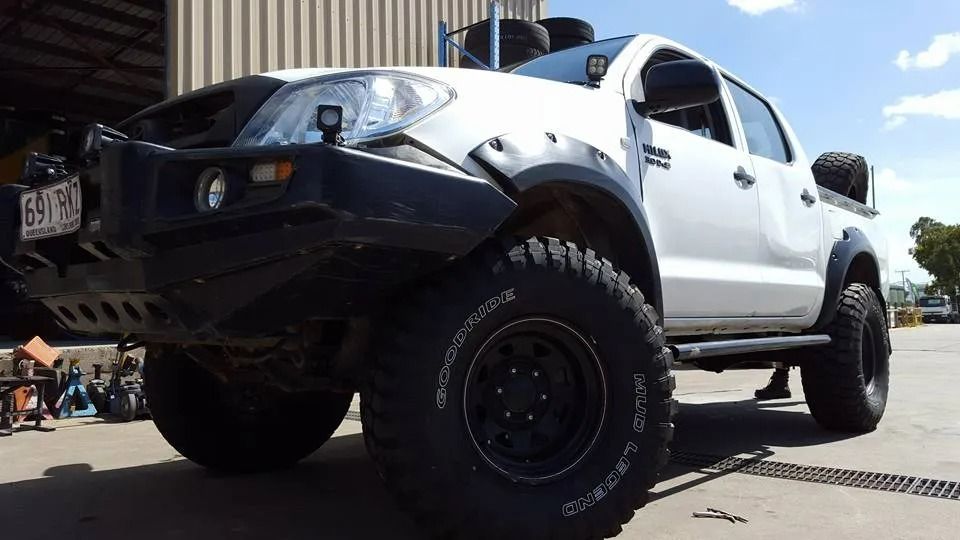 A White 4x4 Pickup Truck With Large Off-road Tires — THG Tires in Gladstone Central, QLD