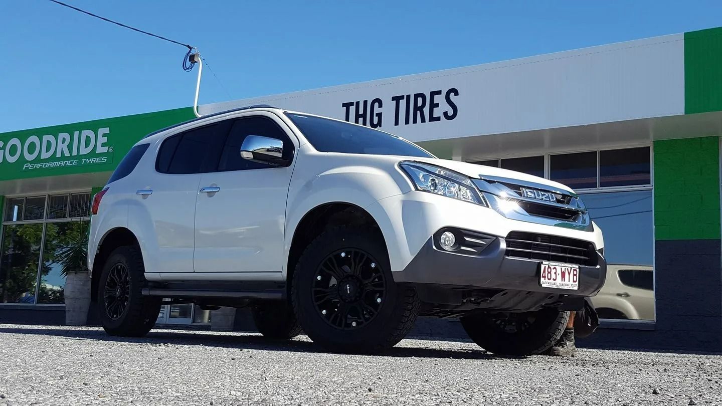 A White Isuzu Mu-x Suv With Black Rims Parked — THG Tires in Gladstone Central, QLD